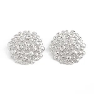 Detail view of silver-tone hollow honeycomb stud earrings with a liquid metal texture.