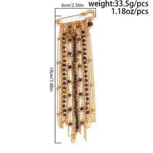 Detailed view of vintage tiger eye sunflower brooch with gold star tassel chains