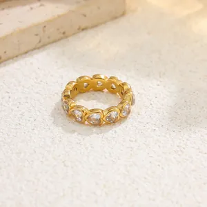 Macro view of gold-plated stainless steel eternity ring with heart-shaped zircons.