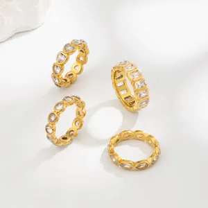 Detail of various gold-plated stainless steel rings with different cubic zirconia shapes.