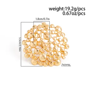 Close-up of oversized gold hollow honeycomb mesh earrings with detailed size measurements