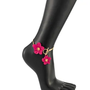 Detail of pink flower charms on a gold snake chain anklet with OT toggle clasp.