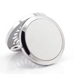 Macro view of a circular stainless steel aromatherapy pendant with a fine brushed metal finish