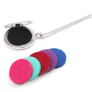 Close-up of open stainless steel diffuser locket necklace with colorful felt pads
