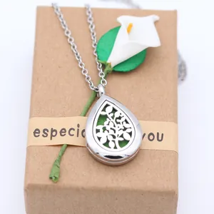 Macro view of a silver water drop aromatherapy locket on a craft paper gift box