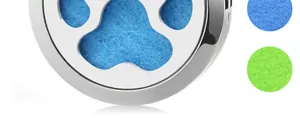 Detail shot of hollow-out paw print stainless steel aromatherapy locket with blue felt pad