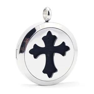 Close-up detail of a stainless steel cross aromatherapy essential oil diffuser locket