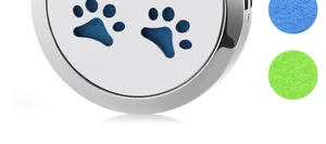 Macro detail of paw print hollowed stainless steel aromatherapy pendant with felt pads