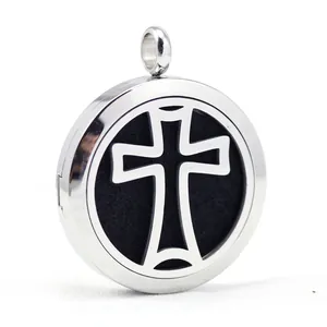 Detailed macro shot of a stainless steel cross locket aromatherapy pendant with black felt.