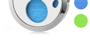 Macro view of stainless steel aromatherapy diffuser locket showing fiber texture of felt pads