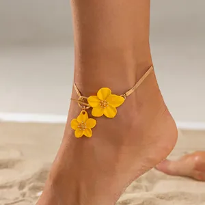 Beach vacation gold snake chain anklet featuring two yellow enamel flowers and OT clasp.