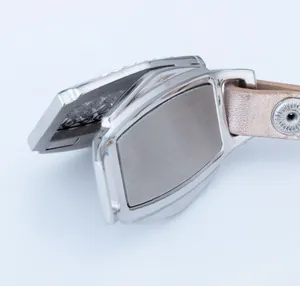 Close-up of open stainless steel aromatherapy locket with leather strap and crystal accents.