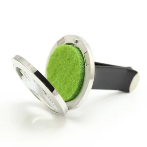 Detail view of open stainless steel car vent diffuser locket with green felt pad