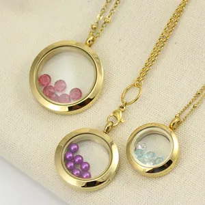 Detailed view of gold round stainless steel glass locket pendants with colorful rhinestones