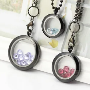 Close-up of black floating lockets with colorful crystals and stainless steel chains