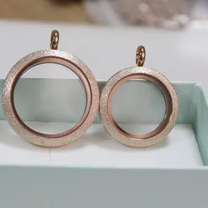 Close-up of rose gold stainless steel magnetic glass locket with sandblasted finish