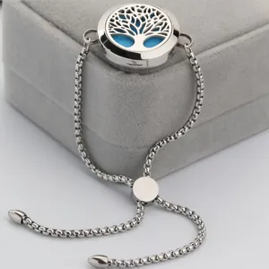 Macro view of stainless steel aromatherapy diffuser bracelet featuring Tree of Life locket