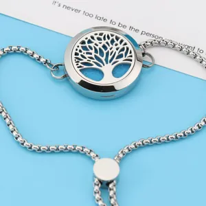 Detail view of a 25mm stainless steel Tree of Life locket bracelet with blue felt pad.