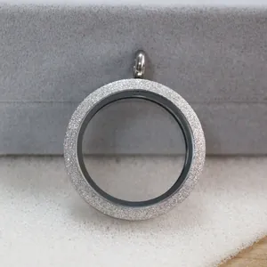 Detail of round stainless steel floating locket featuring frosted silver frame