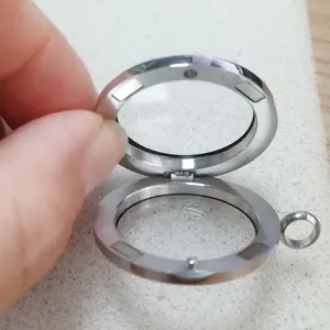 Detailed macro view showing the magnetic opening of a stainless steel floating locket.