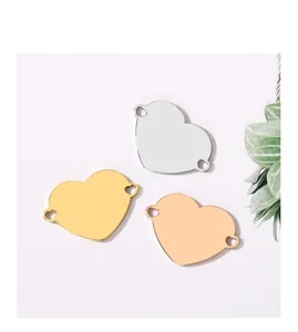 Detail view of heart-shaped stainless steel charms in three metallic finishes