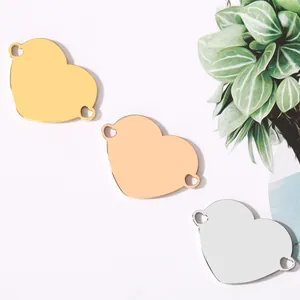 Stainless steel heart pendant charms with double holes in gold, silver, and rose gold.