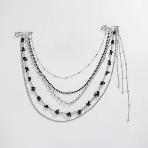 Detailed macro view of a punk hip-hop multi-layer silver chain brooch with black stones
