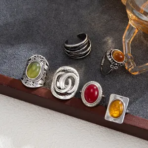 Detailed view of retro ring set with colorful stones and antique silver filigree design