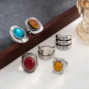 Close-up view of vintage French style rings with colorful gemstones and chunky silver finish
