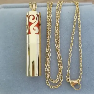 Close-up of golden stainless steel tube pendant for essential oil diffusion
