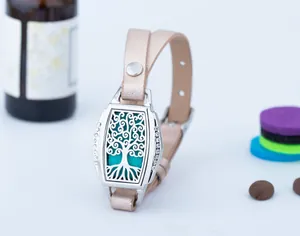 Detail view of a rectangular tree of life aromatherapy diffuser bracelet with leather strap