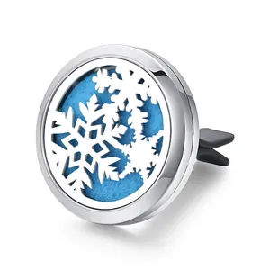 Macro view of a stainless steel car vent aromatherapy diffuser with a snowflake hollow design