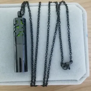 Black stainless steel cylindrical perfume diffuser necklace with hollow floral design