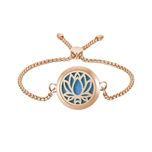 Close-up of rose gold aromatherapy bracelet with lotus locket and blue felt pad.