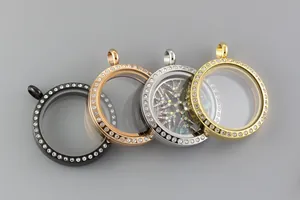 Close-up of stainless steel round rhinestone-set glass locket pendants in four metallic colors.