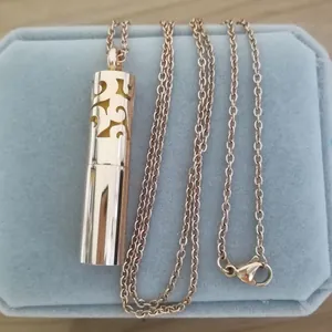 Gold stainless steel aromatherapy locket necklace displayed on a blue velvet box