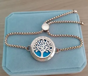 Close-up of rose gold tree of life aromatherapy locket bracelet on velvet box