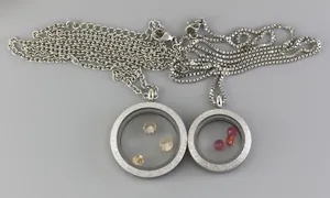 Close-up detail of stainless steel glass locket pendants with colorful sparkling gemstones