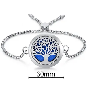 Close-up view of the 30mm Tree of Life aromatherapy locket bracelet with a blue pad