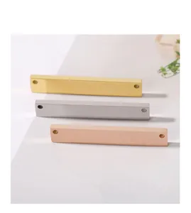 Detailed view of three stainless steel bar pendants in gold, silver, and rose gold finishes.