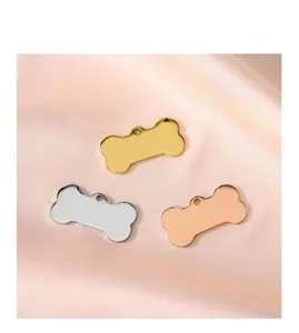 Set of three mirror-polished bone-shaped dog tags in gold, silver and rose gold metal.