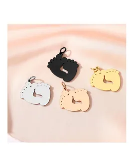 Detail of polished stainless steel baby footprint charms in four colors for DIY jewelry.