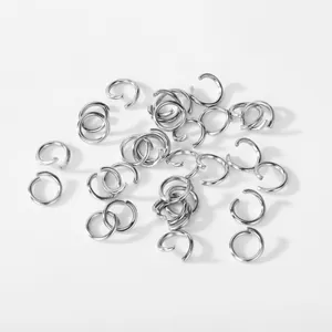 Macro view of scattered silver 304 stainless steel open jump rings for DIY jewelry making
