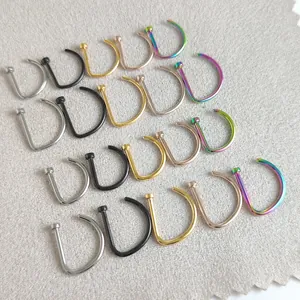 Selection of D-shaped titanium steel nose rings in silver black gold and rainbow colors