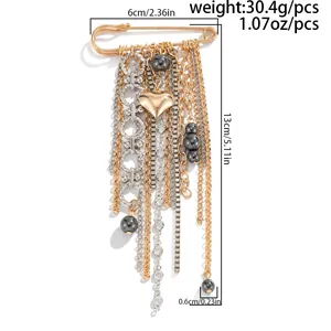 Detailed view of gold multi-layer tassel brooch with heart, beads and dimensions