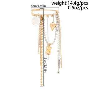 Detail view of gold tassel brooch with heart and bear charms showing product dimensions