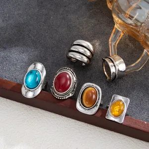 Detail of vintage engraved rings with colorful gemstones in antique silver finish