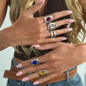Close-up detail of vintage French style silver rings with colorful oval gemstones
