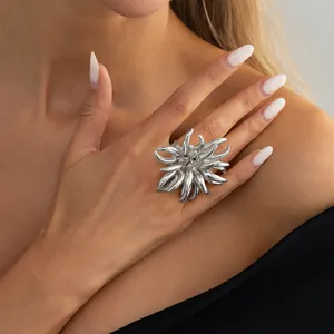 Detail view of a creative 3D silver alloy ring in firework flame shape on a model's hand.