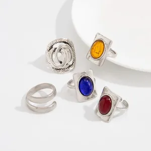 Detailed view of vintage distressed silver rings featuring colorful oval gemstones